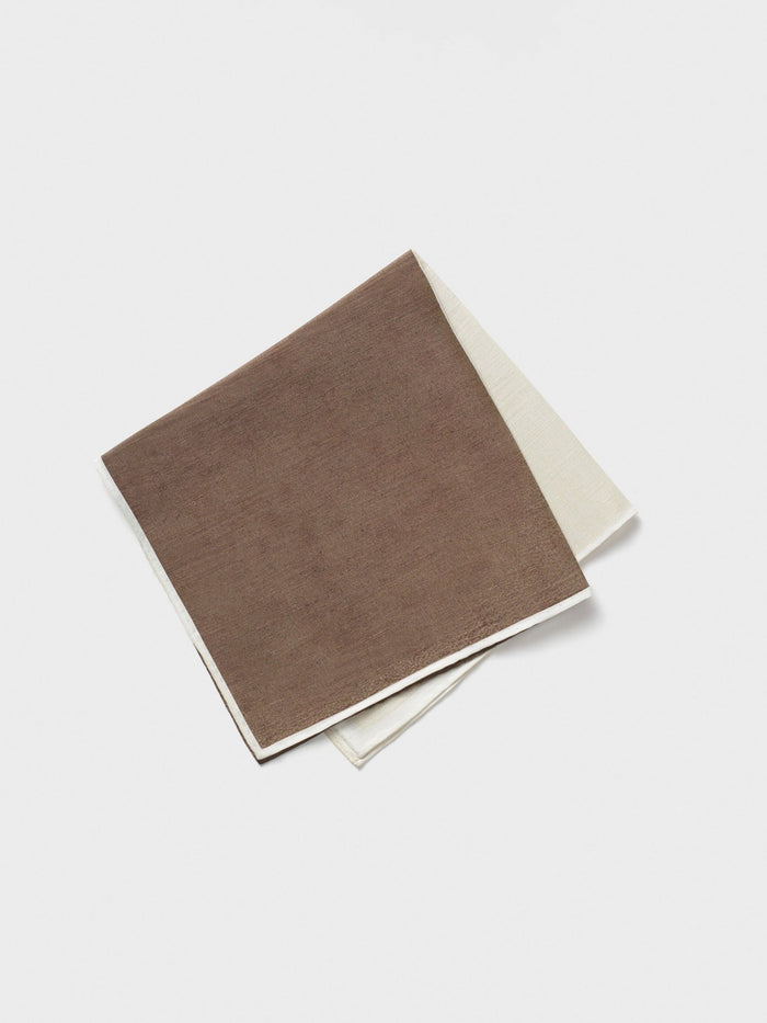 Brown and cream pocket squares stacked diagonally on a light background.