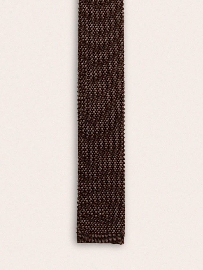 Close-up of brown silk knit tie fabric texture, vertical view.