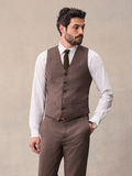 Man in a brown suit vest, white shirt, and olive tie, cropped front view.