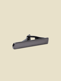 Brushed silver tie bar with a rounded tip, angled side view.