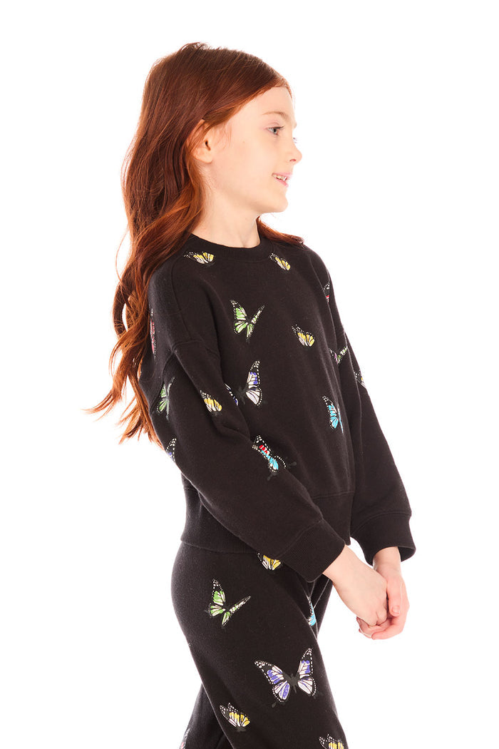 Side view of girl wearing Chaser’s Blondie Leopard & Hearts print pullover top with red text on a white background