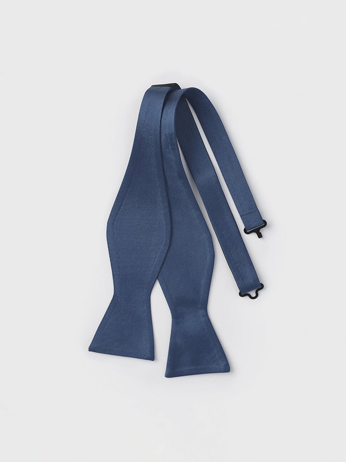 Cadet blue butterfly bow tie, untied and laid out on a light background.