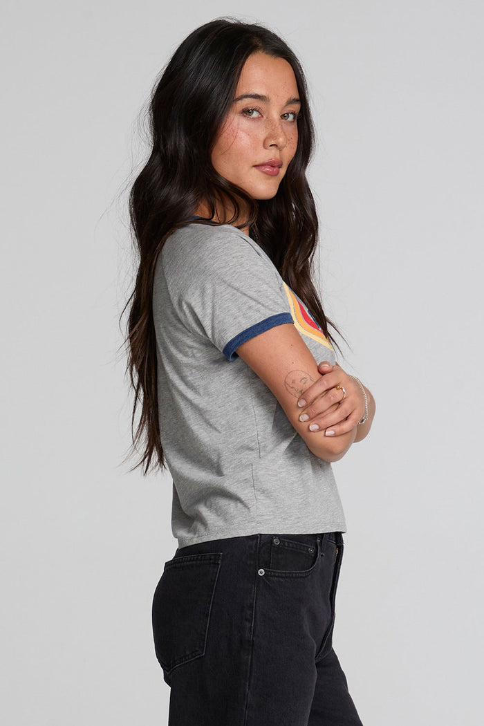 Back view of a woman wearing the Chaser California Dreamin Tee and black pants on a neutral background