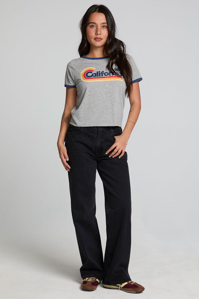 A full body front view of a woman wearing the Chaser California Dreamin Tee on a neutral background