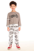 Full body view of boy wearing Chaser’s Camo Pants in gray camouflage with matching Moto Rider top on a white background.