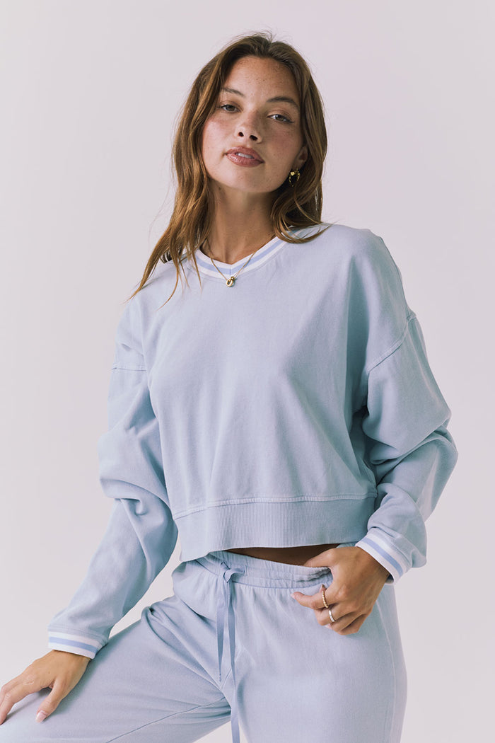 Chaser Campbell Bluebird Pullover shown from the front in soft bluebird with a relaxed cropped fit and ribbed hem styling