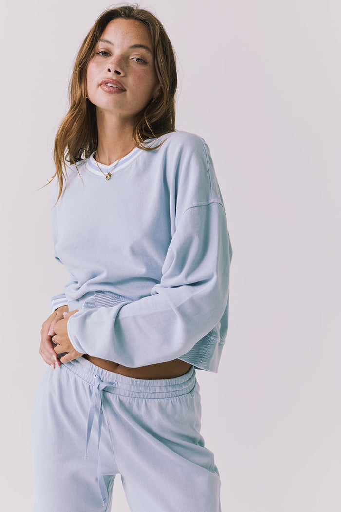 Chaser Campbell Bluebird Pullover detail view focusing on the ribbed cuffs, neckline trim, and soft brushed fabric texture