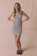Editorial shot of the Chaser Capri Daytime Stripe Mini Dress against a neutral backdrop styled with woven flats