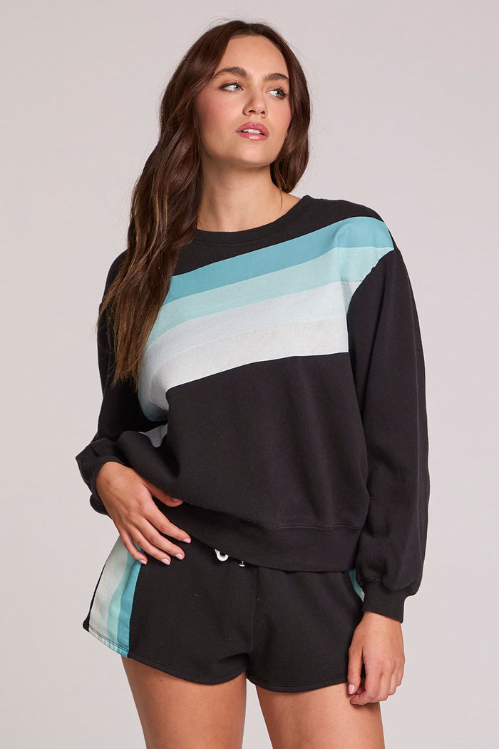 Front view of a woman wearing the Chaser  Cashbah Black Pullover on a neutral background