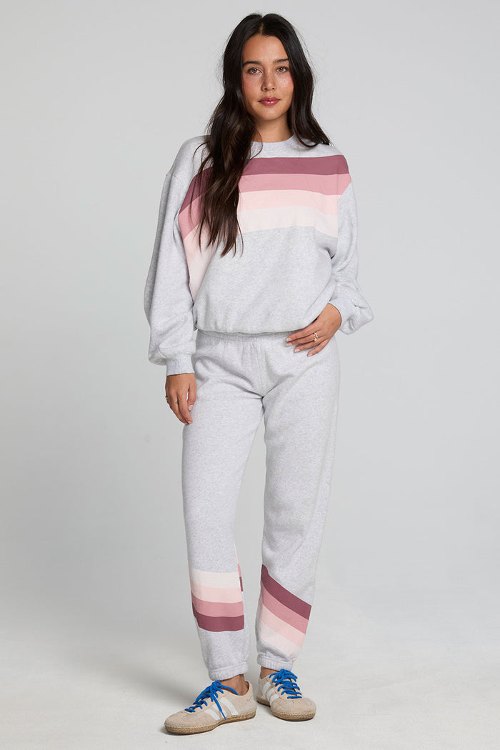 Full body front view of a woman wearing the Chaser Cashbah Heather Grey Pullover and grey matching pants on a neutral background