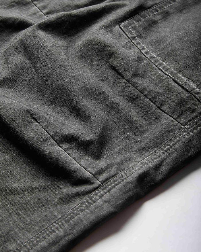 Close-up of dark gray pants on a white background