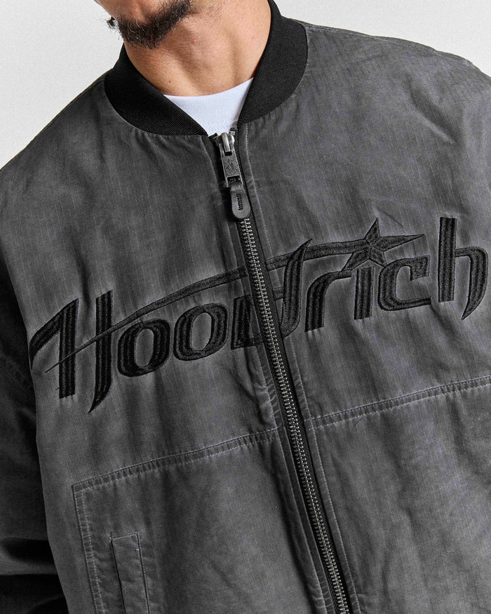 Gray bomber jacket with 'Hoodrich' branding across the chest on a plain background