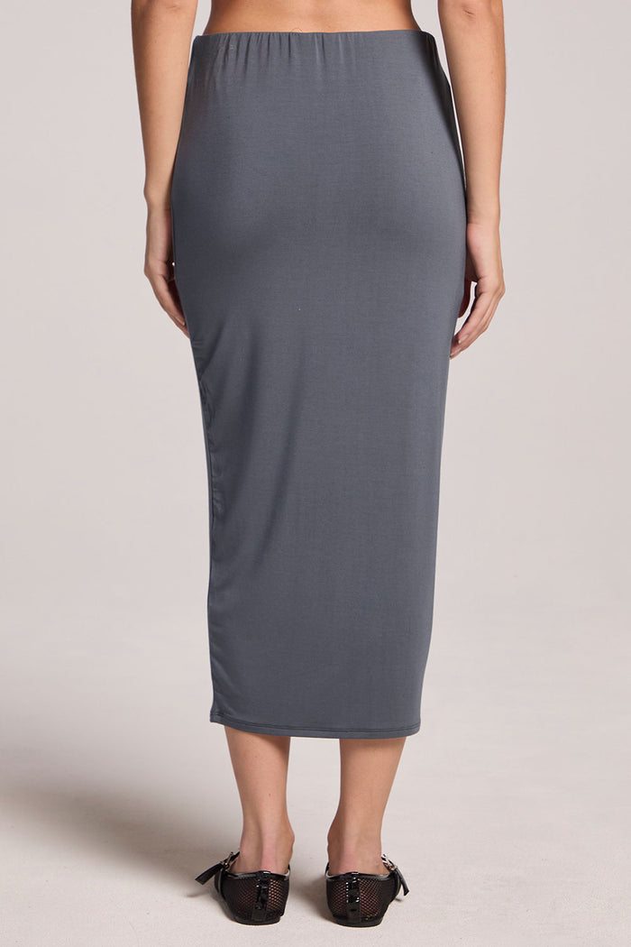Back view of a woman wearing the Chaser Future Grey Catch Midi Skirt on a neutral background