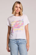 Front view of a woman wearing the Chaser  Catch Of The Day Tee and jeans on a neutral background