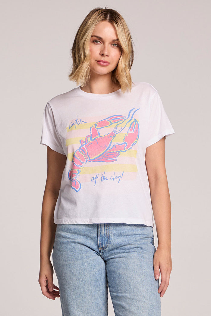 Front view of a woman wearing the Chaser  Catch Of The Day Tee and jeans on a neutral background