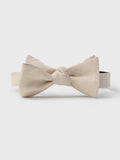 Champagne linen and silk bow tie, tied, front view on a light background.