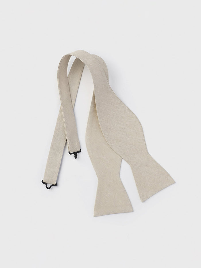 Champagne linen and silk bow tie, untied and laid flat.