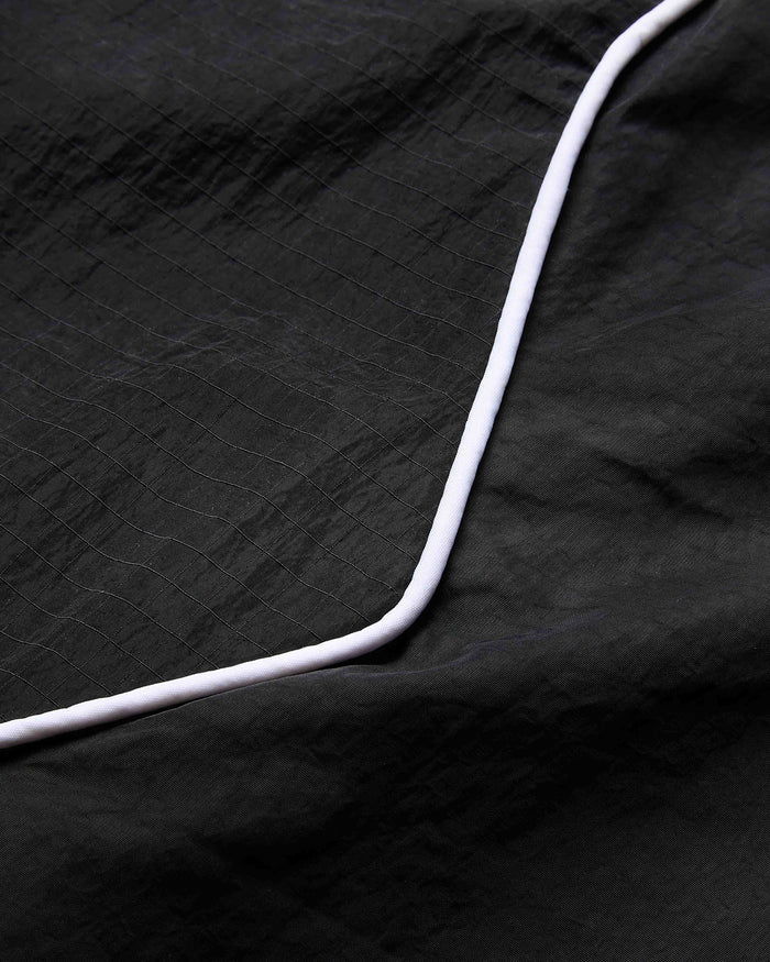 Close-up of a black textured fabric with a white edge