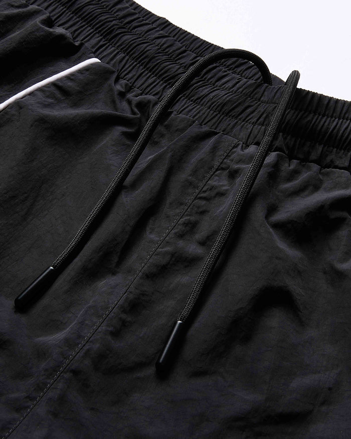 Close-up of black shorts with drawstring on a light gray background