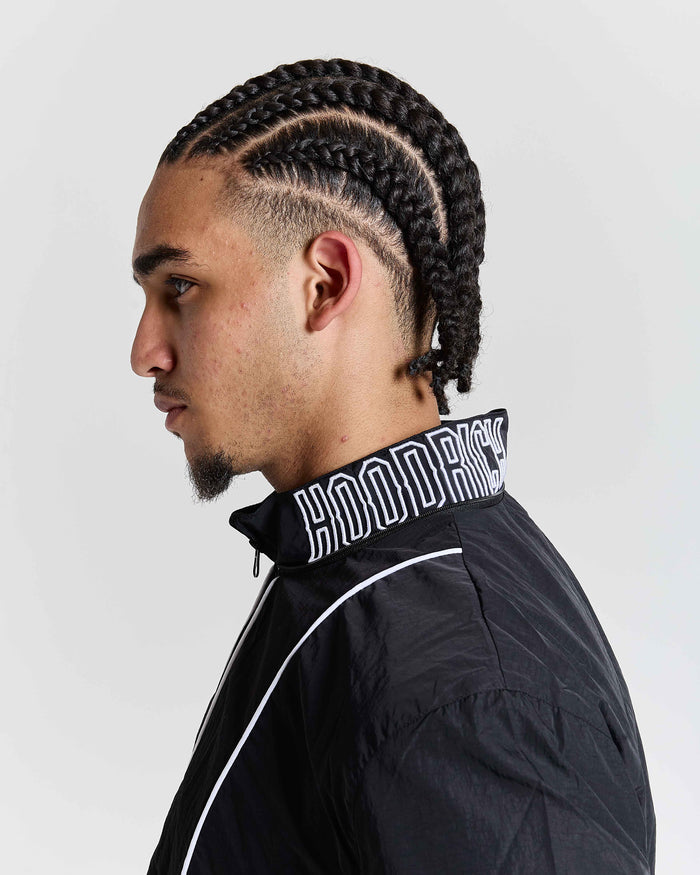 Person wearing a black jacket with 'Hoodrich' branding on a white background