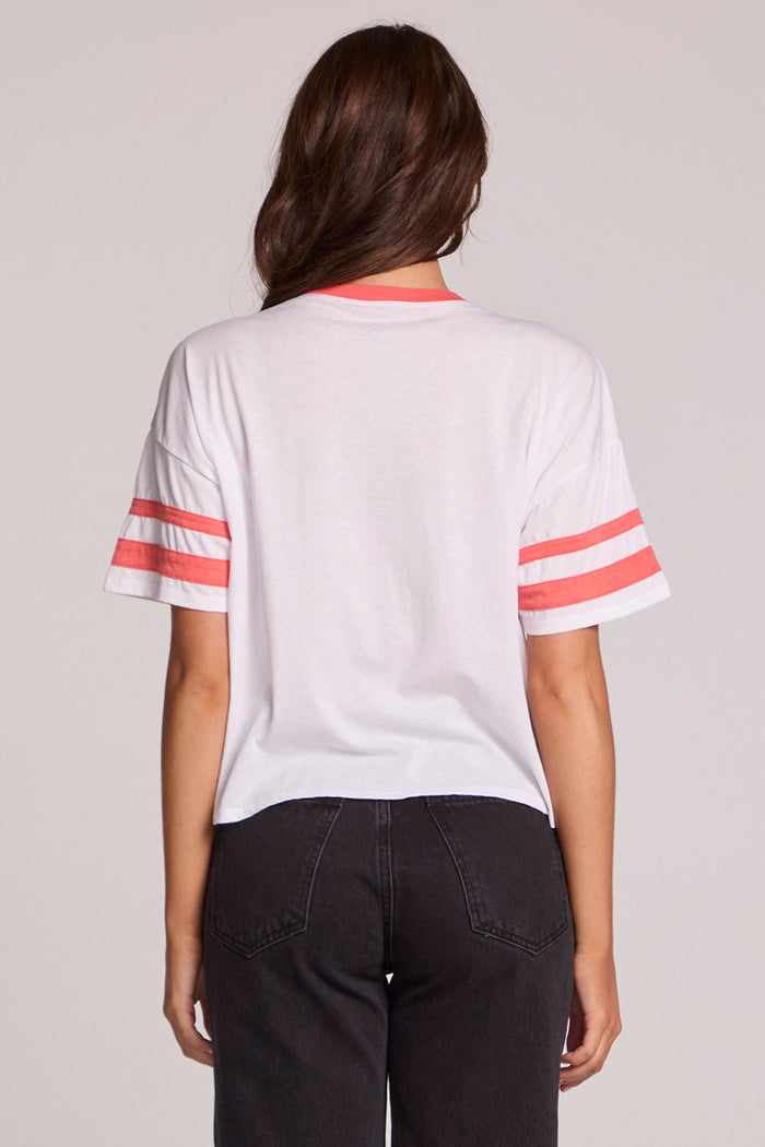 Back view of a woman wearing the Chaser Teddy Tee on a neutral background and pants