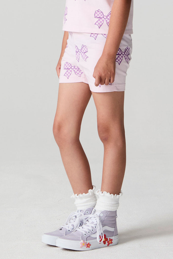 Side view of a girl wearing the Chaser Check Bow Shorts on a neutral background