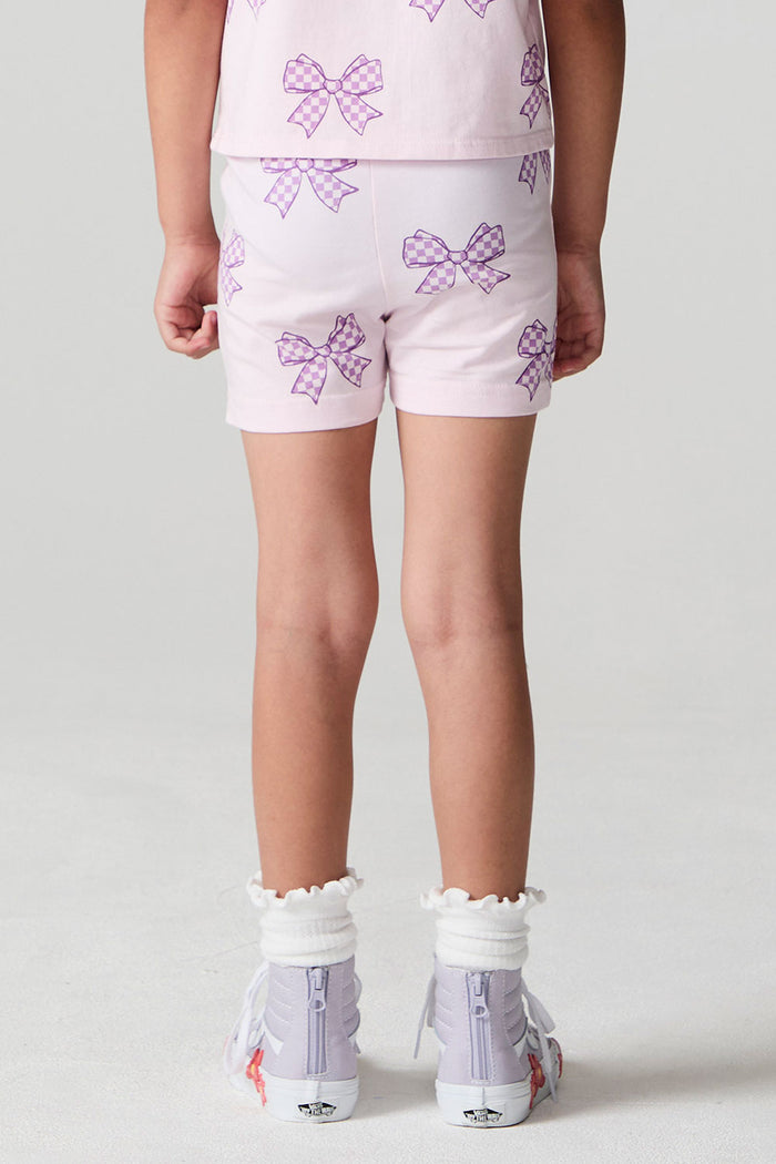 Back view of a girl wearing the Chaser Check Bow Shorts on a neutral background