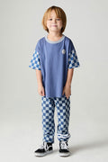 Full body front view of a boy wearing the Chaser  Checkered Pants Boys Jogger on a neutral background with matching smiley shirt