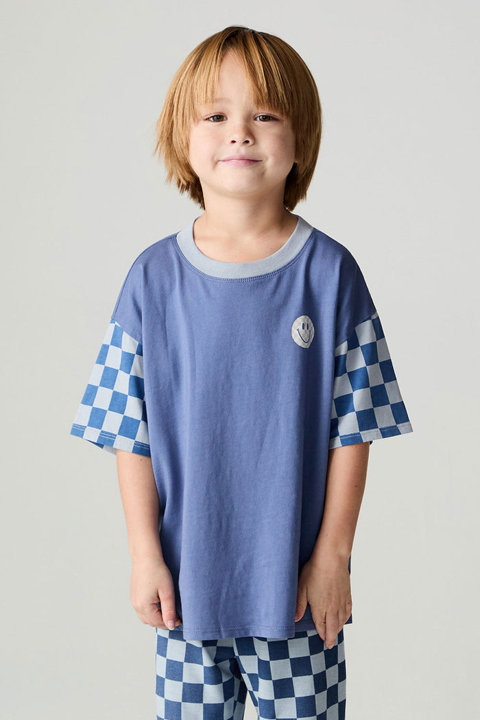 Front view of a boy wearing the Chaser Smileys Boys Tee on a neutral background with matching checkered pants
