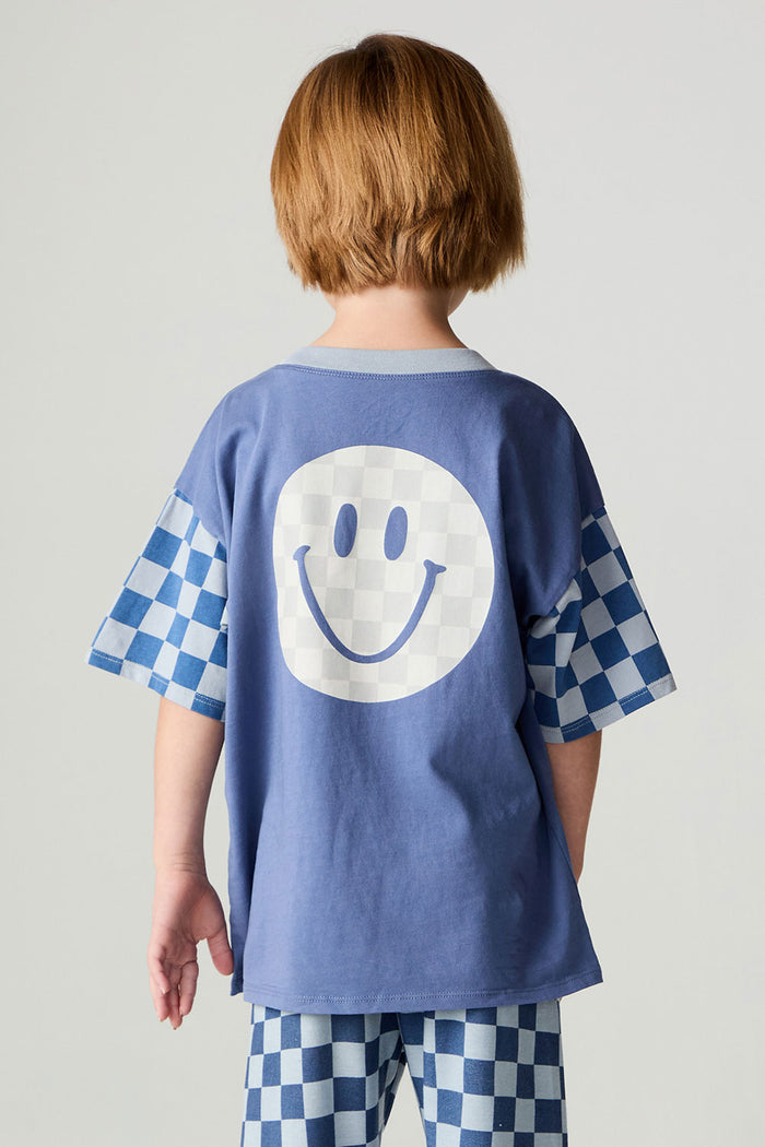Back view of a boy wearing the Chaser Smileys Boys Tee on a neutral background with pants