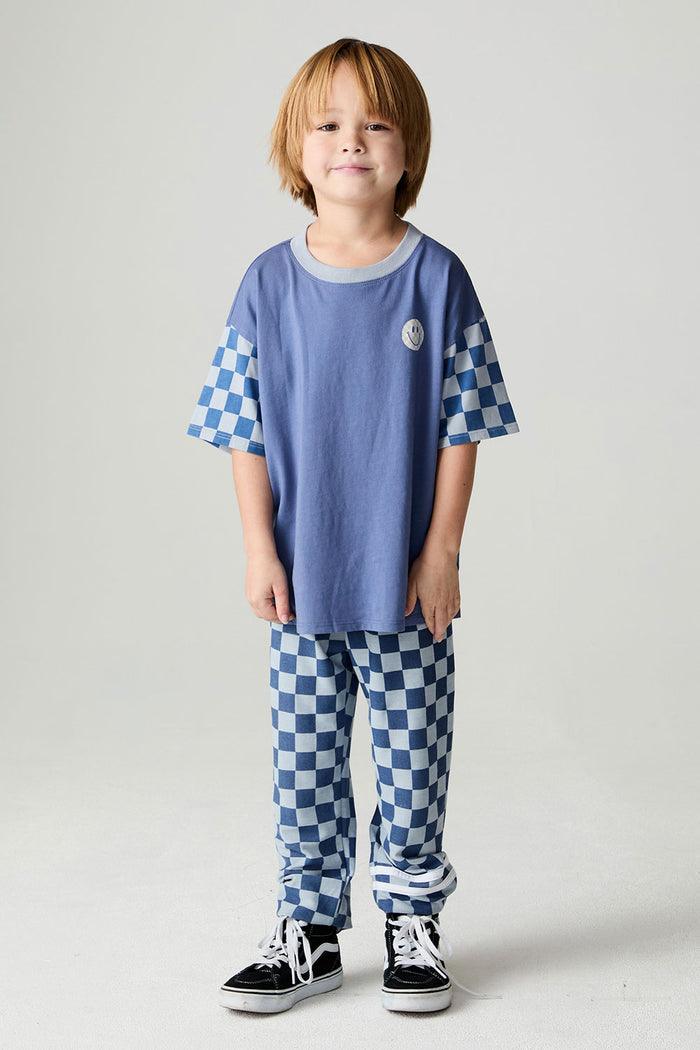 A full body front view of a boy wearing the Chaser Smileys Boys Tee on a neutral background