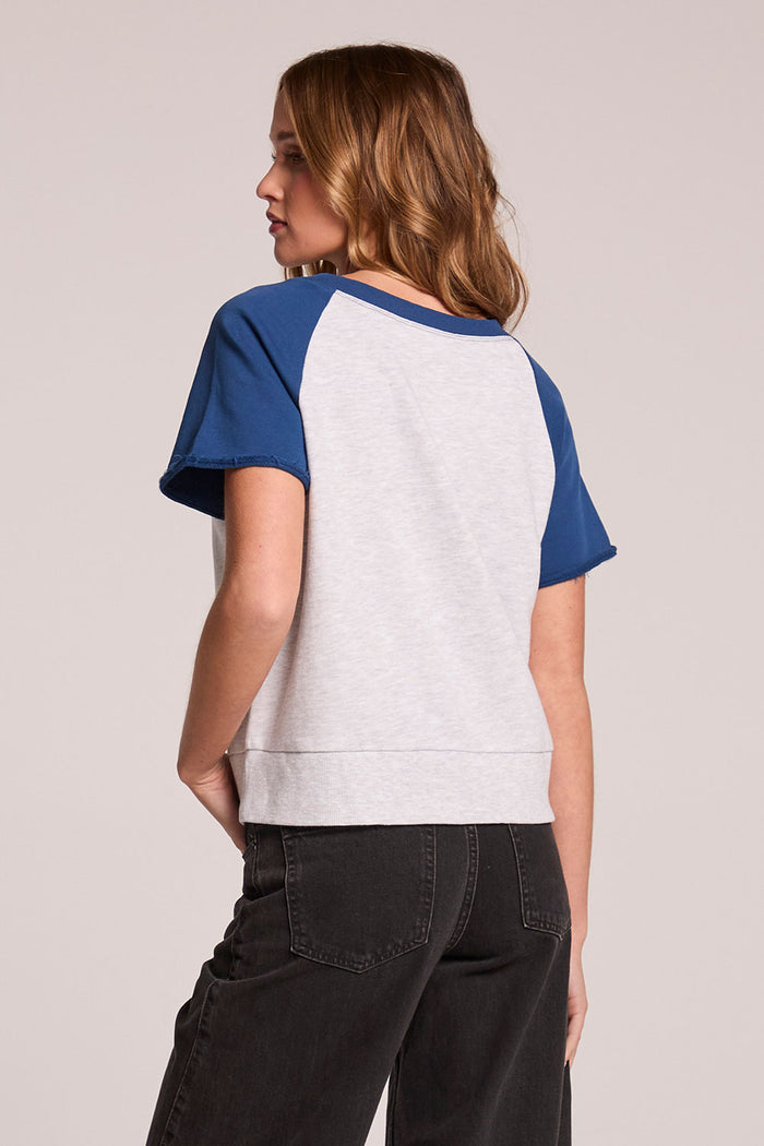 A back view of a woman wearing the Chaser Cheyenne Admiral and Light Grey Pullover  on a neutral background