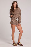 Full body front view of a woman wearing the Chaser  Clary Leopard Ribbed Shorts on a neutral background with matching shorts