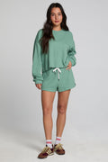 Back view of a woman wearing the Chaser Clary Verdelle Relaxed Shorts matching set on a neutral background