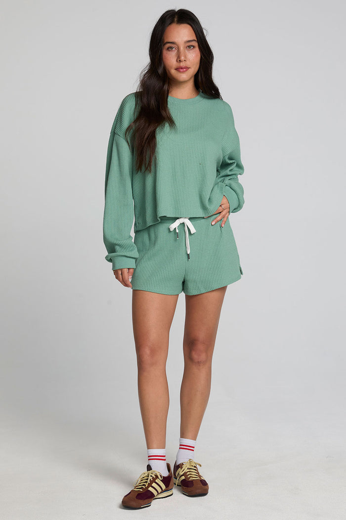 Back view of a woman wearing the Chaser Clary Verdelle Relaxed Shorts matching set on a neutral background