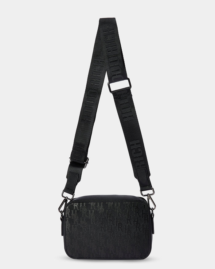 Black textured bag with a strap on a light gray background