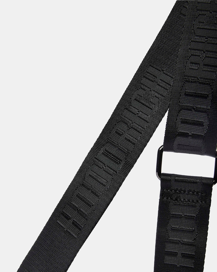 Black belt with branding on a light gray background