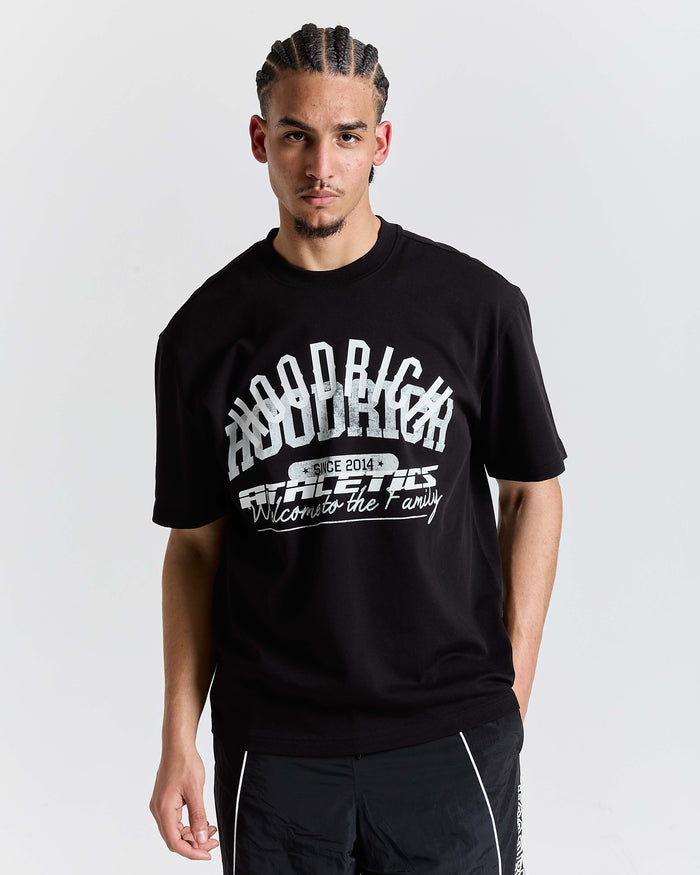 Man wearing a black t-shirt with white text on a plain background
