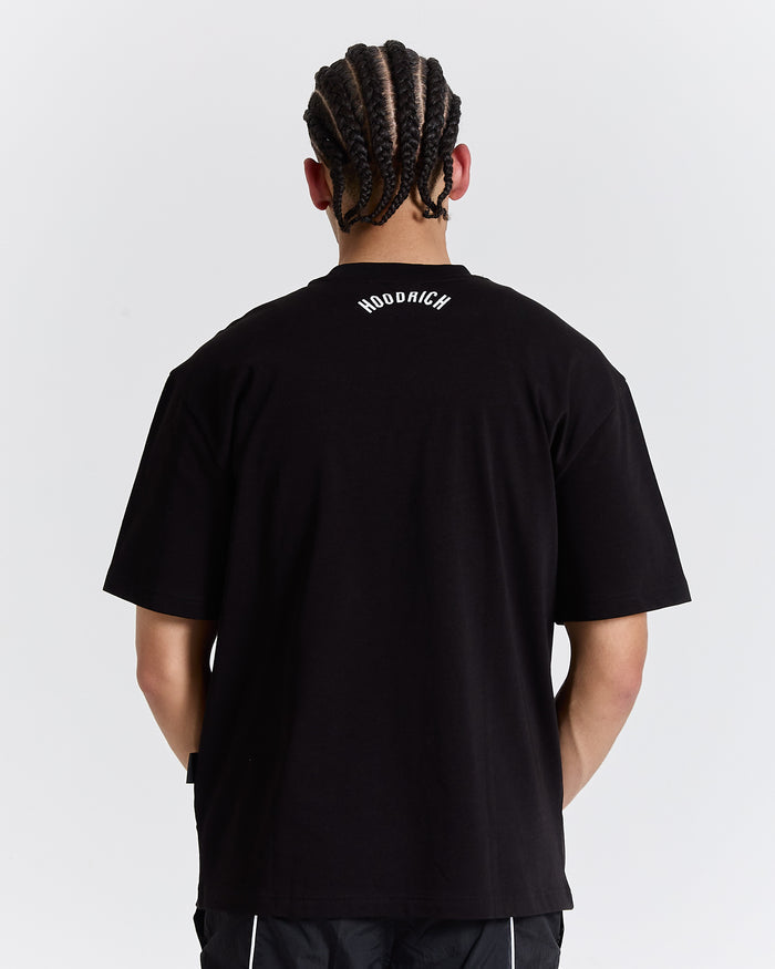 Person wearing a black t-shirt with text on the back against a white background