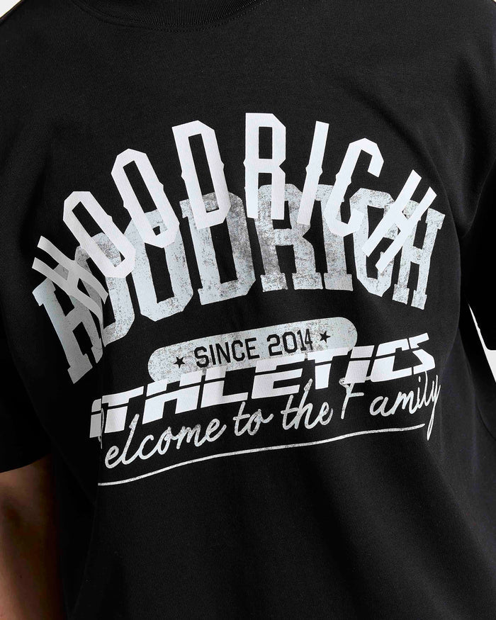 Black t-shirt with white text and graphics on a person wearing it.