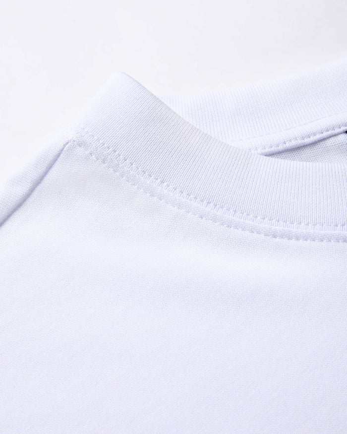 Close-up of a white fabric with a subtle pattern on a white background