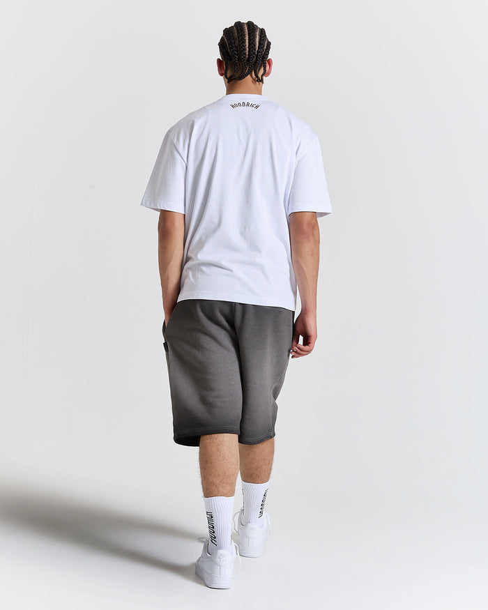 Person wearing a white t-shirt and gray shorts on a plain background
