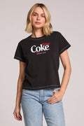 Front view of a woman wearing the Chaser Coca Cola Diet Coke Tee on a neutral background with her hand in one pocket