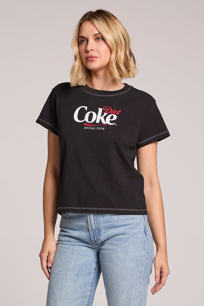 Side angle view of a woman wearing the Chaser Coca Cola Diet Coke Tee on a neutral background