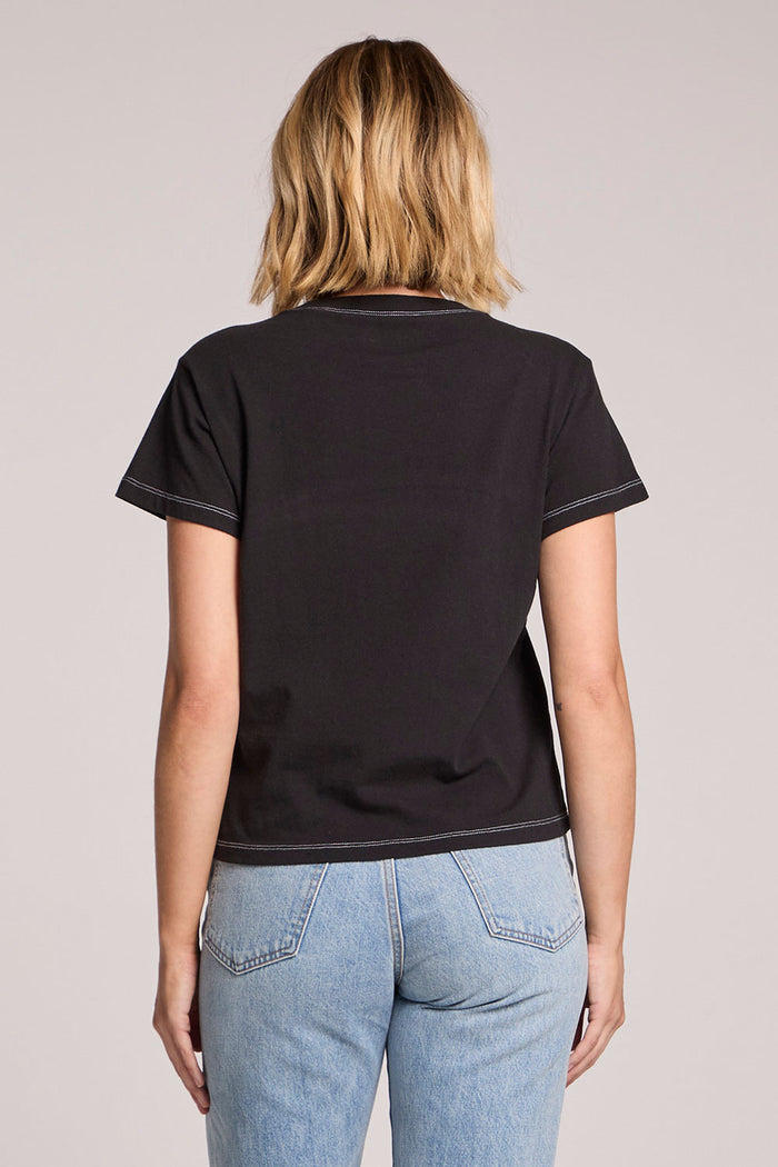 Back view of a woman wearing the Chaser Coca Cola Diet Coke Tee on a neutral background
