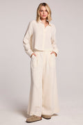 Woman wearing the Chaser Coconut Milk Campaniaa Trousers set on a neutral background