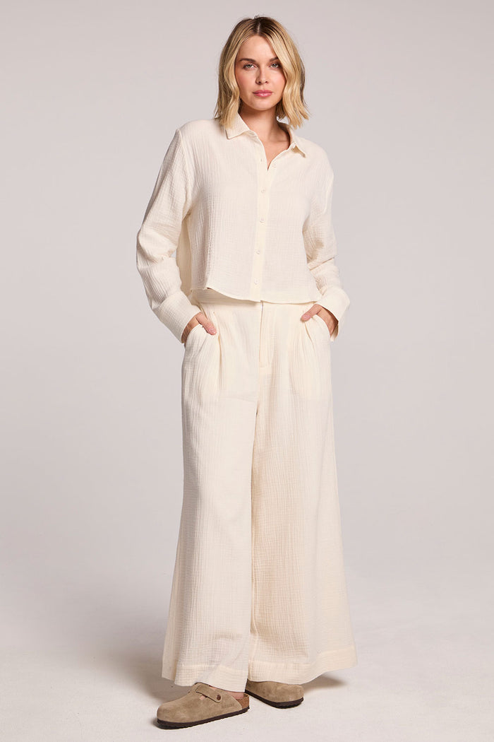 Woman wearing the Chaser Coconut Milk Campaniaa Trousers set on a neutral background