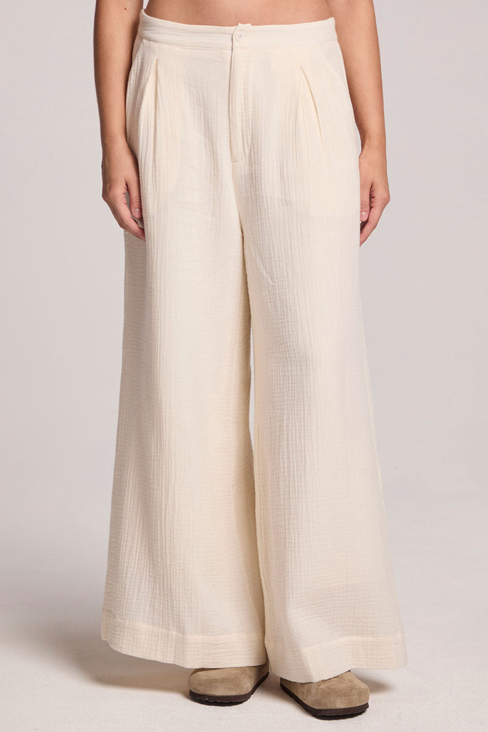 Front view of a woman wearing the Chaser Coconut Milk Campaniaa Trousers on a neutral background