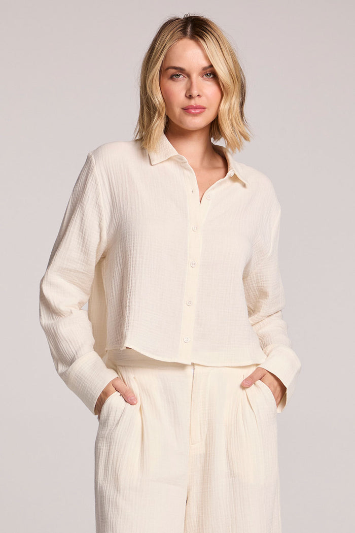 Front view of a woman wearing the Chaser Paso Crop Button Up on a neutral background