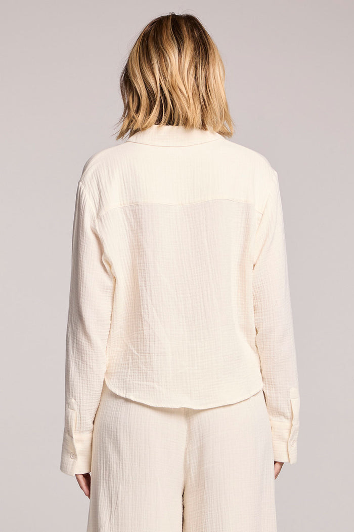 Back view of a woman wearing the Chaser Paso Crop Button Up on a white background